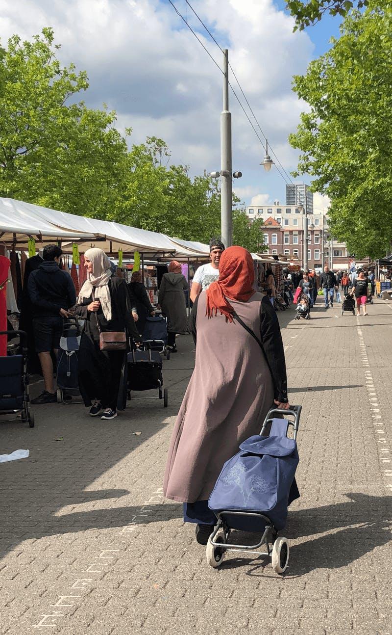 Photo of a market in Rotterdam with people walking. Image belongs to the project 'The public markets of Rotterdam' by Business Design Agency